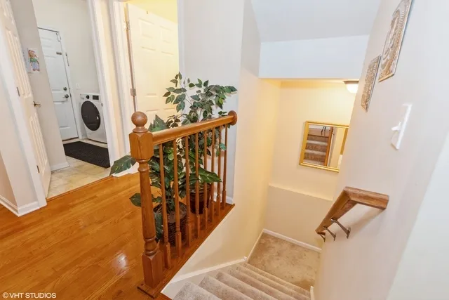 a view of entryway and hall with wooden floor