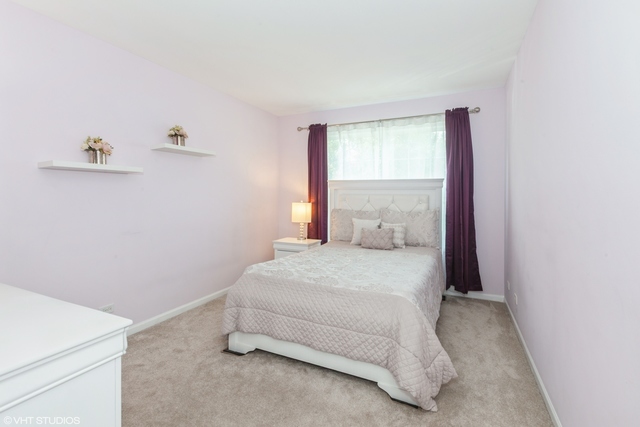 152 Orchards Pass Bartlett, IL 60103 - Photo 17 of 40 a bedroom with a bed and window