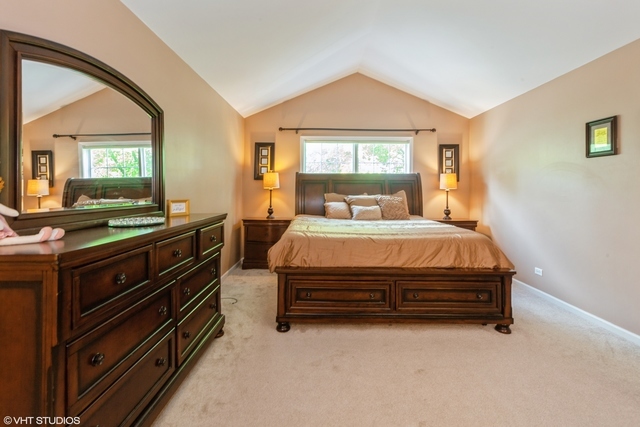 152 Orchards Pass Bartlett, IL 60103 - Photo 20 of 40 a bedroom with a bed and a large window