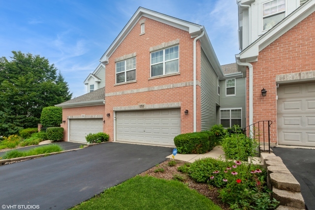 152 Orchards Pass Bartlett, IL 60103 - Photo 2 of 40 a front view of a house with a garden