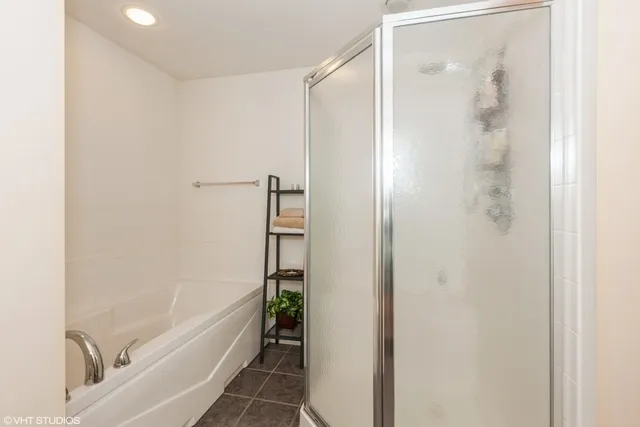 a bathroom with a bathtub and a shower