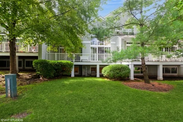 a view of a house with a yard and sitting area