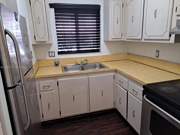 an empty room with fan and windows