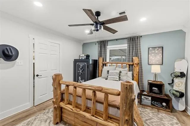 a bedroom with a bed a table and chair