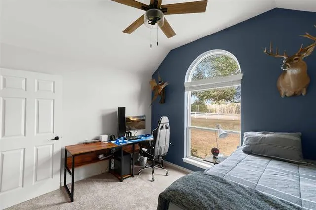 a bedroom with furniture and a window