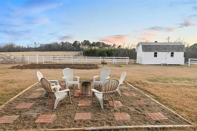 a view of a chairs and table in patio