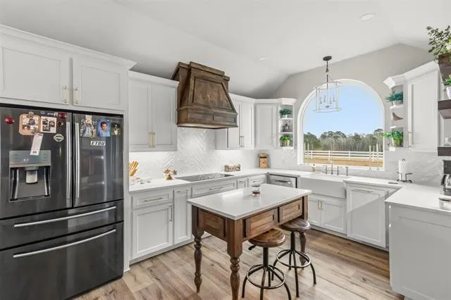a kitchen with stainless steel appliances a sink a stove and a refrigerator