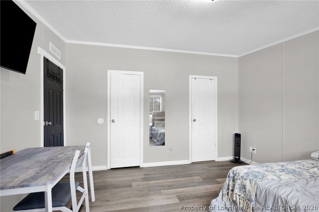 518 Inverary Drive Raeford, NC 28376 - Photo 17 of 30 a bedroom with a bed and a flat screen tv