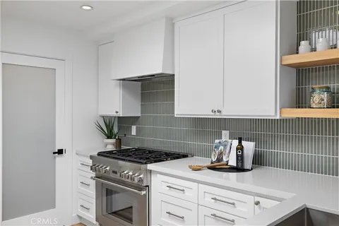 a kitchen with granite countertop a stove and a sink