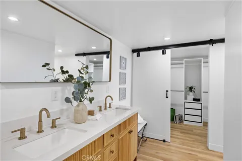 a bathroom with a granite countertop sink a toilet and shower
