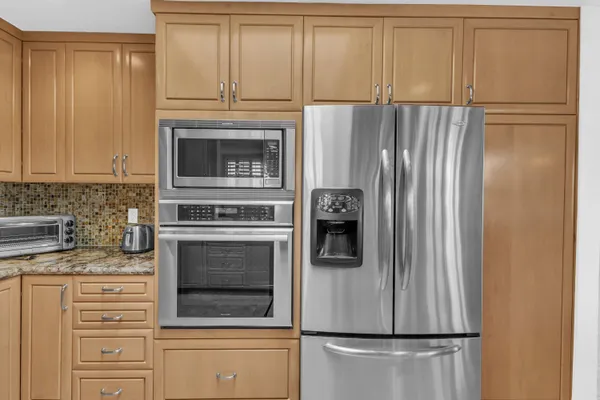 a kitchen with cabinets and stainless steel appliances