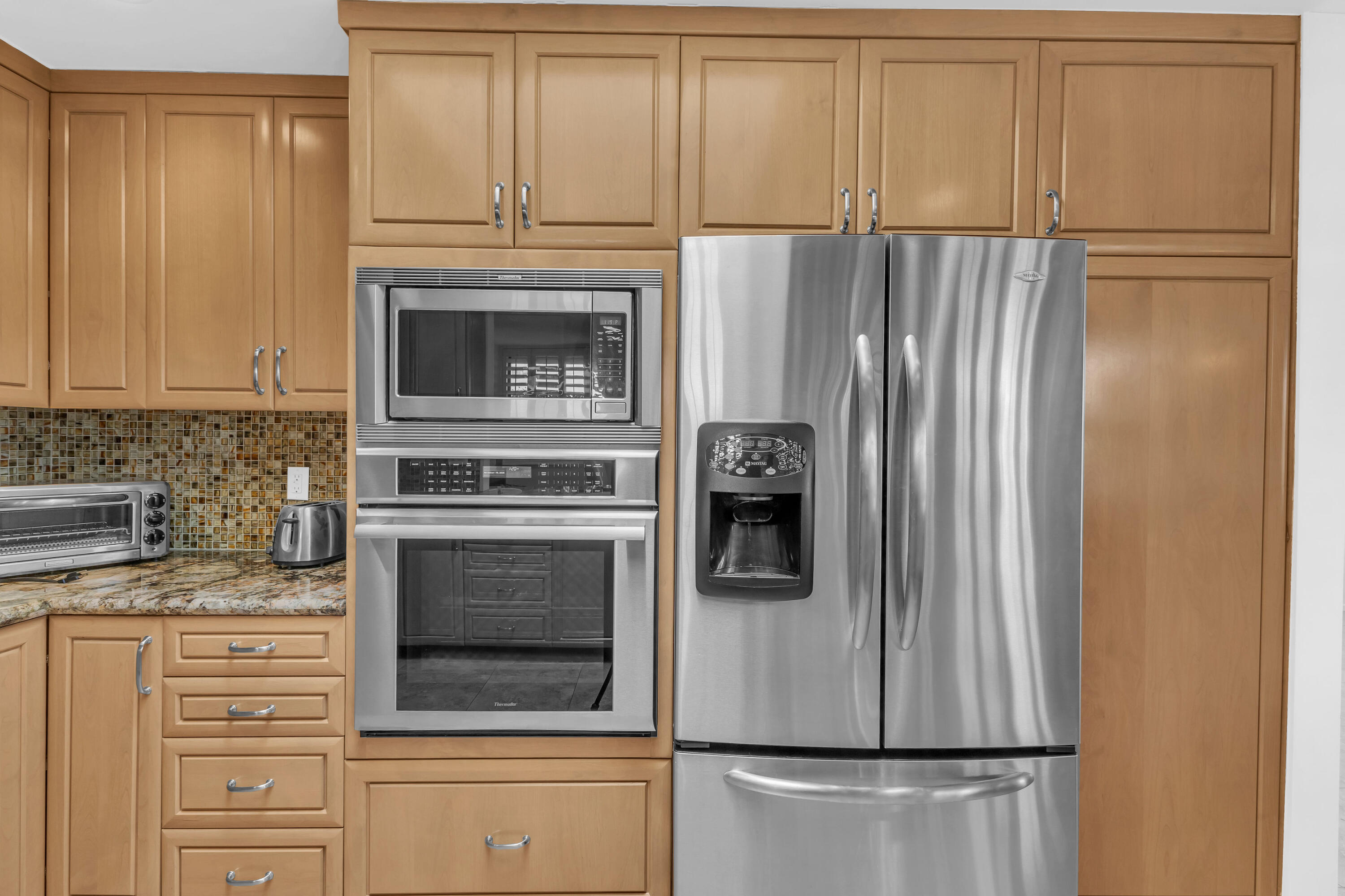 10 Colgate Drive Rancho Mirage, CA 92270 - Photo 15 of 49 a kitchen with cabinets and stainless steel appliances