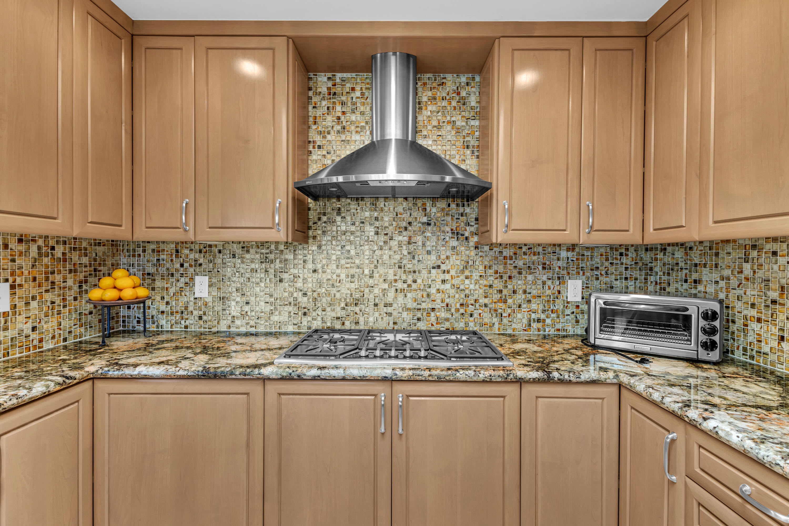 10 Colgate Drive Rancho Mirage, CA 92270 - Photo 16 of 49 a kitchen with stainless steel appliances granite countertop a sink a stove and a wooden cabinets