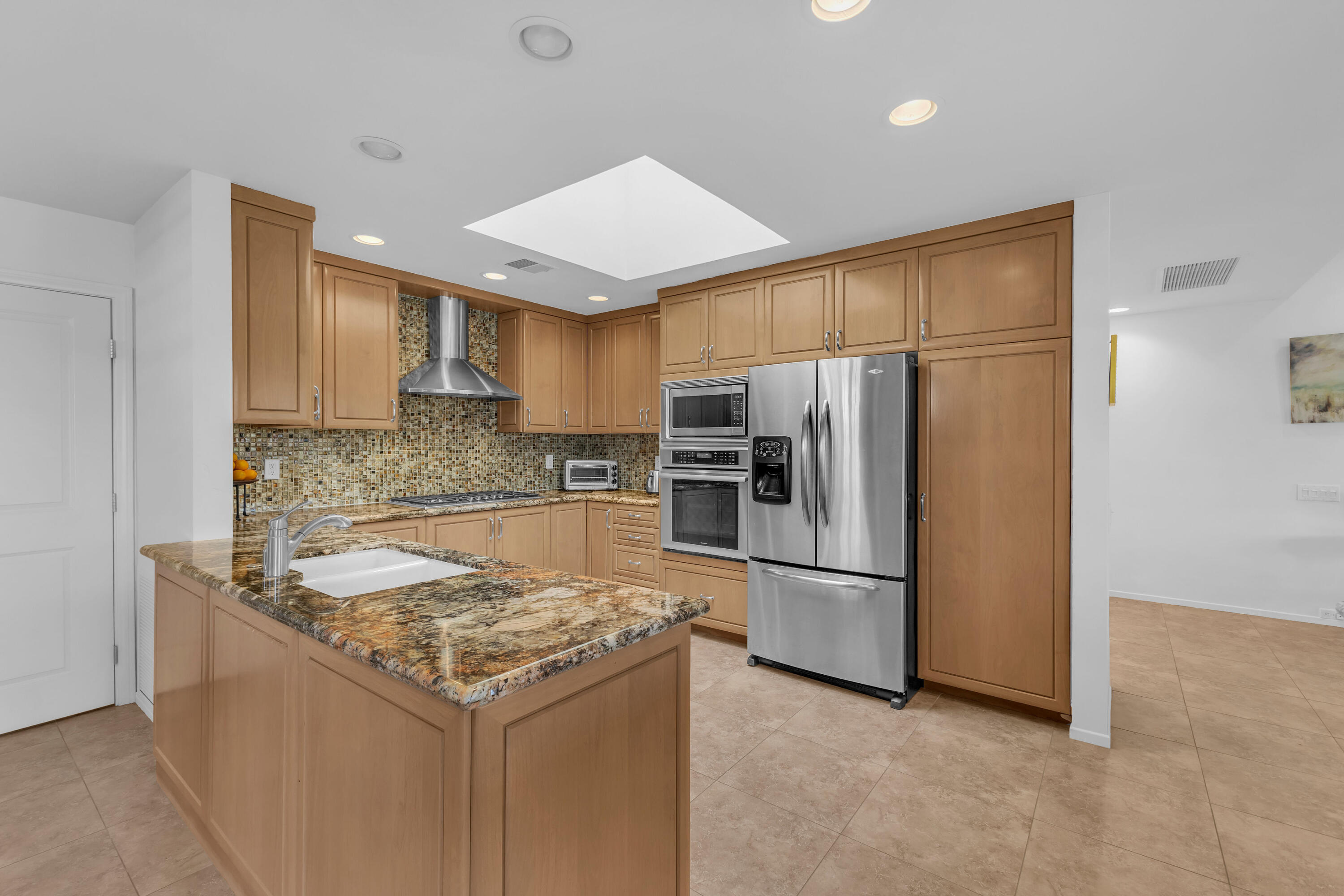 10 Colgate Drive Rancho Mirage, CA 92270 - Photo 17 of 43 a kitchen with a refrigerator a microwave and sink