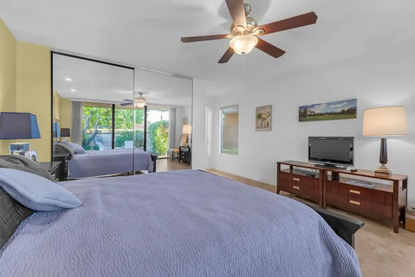 a bathroom with a granite countertop sink a mirror and a shower