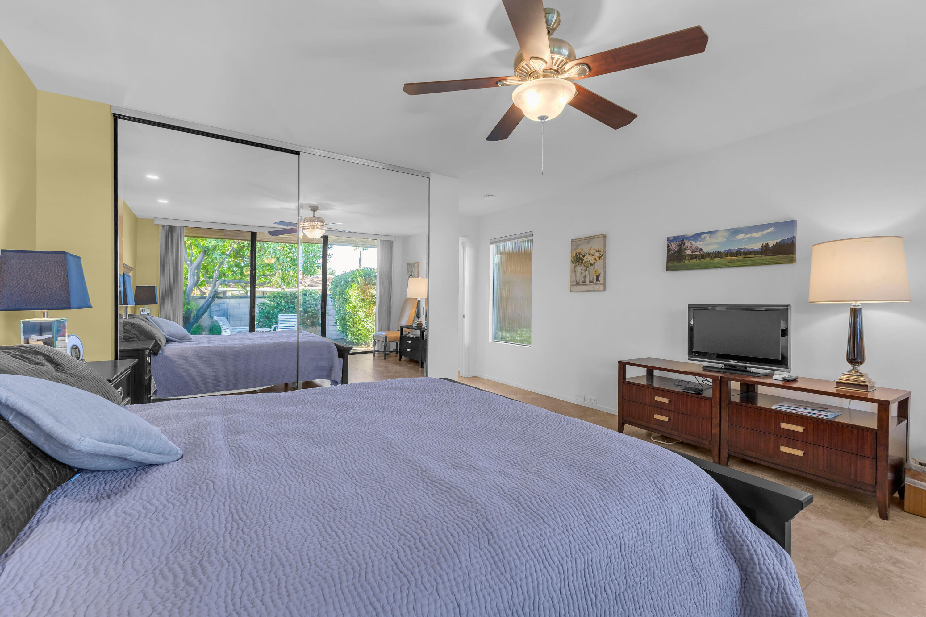 10 Colgate Drive Rancho Mirage, CA 92270 - Photo 31 of 49 a bedroom with a bed flat screen tv and a large window