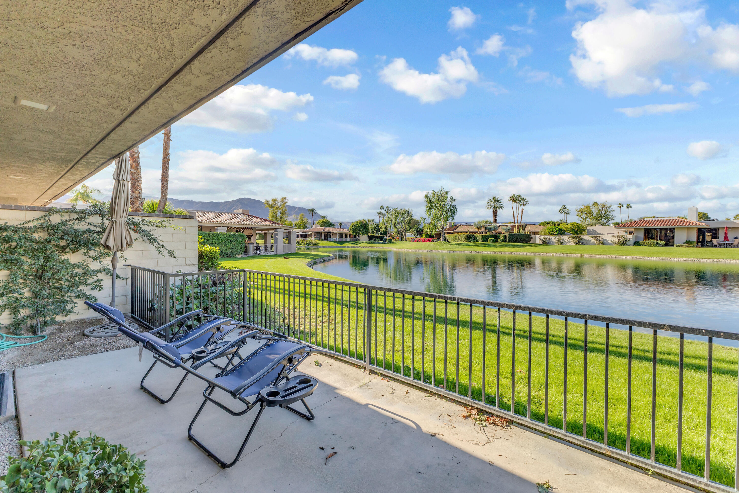 10 Colgate Drive Rancho Mirage, CA 92270 - Photo 38 of 49 a view of swimming pool with outdoor seating and lake