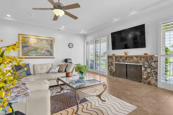 a living room with furniture a flat screen tv and a fireplace