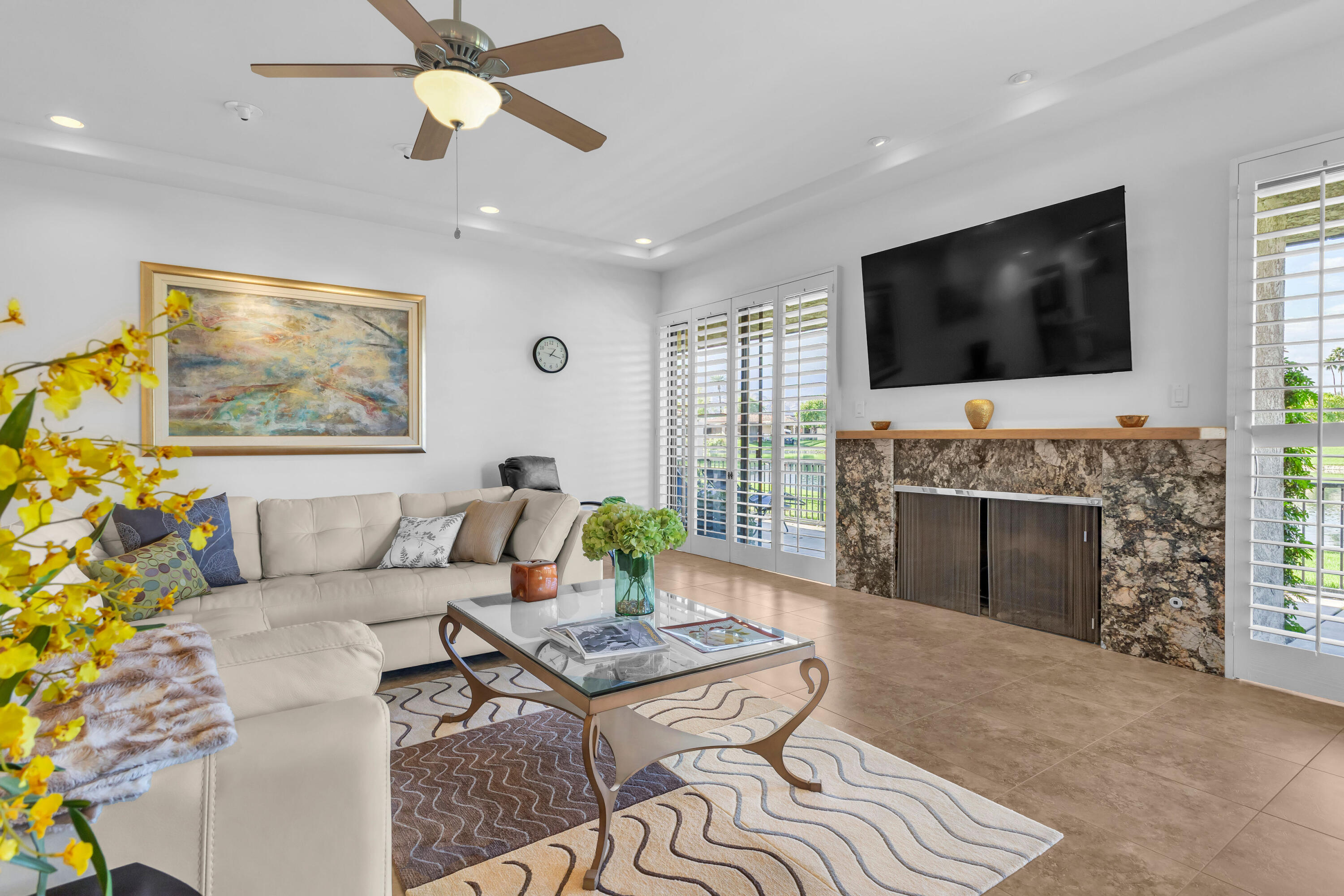 10 Colgate Drive Rancho Mirage, CA 92270 - Photo 7 of 49 a living room with furniture a flat screen tv and a fireplace