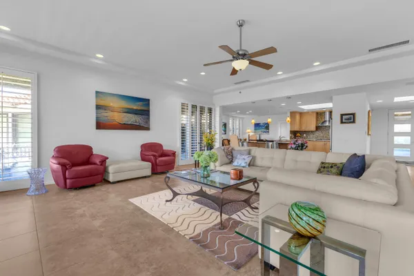 a living room with furniture a window and a flat screen tv