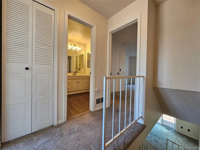 a view of a hallway with wooden floor and entryway