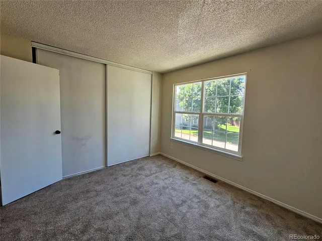 an empty room with a empty space and windows