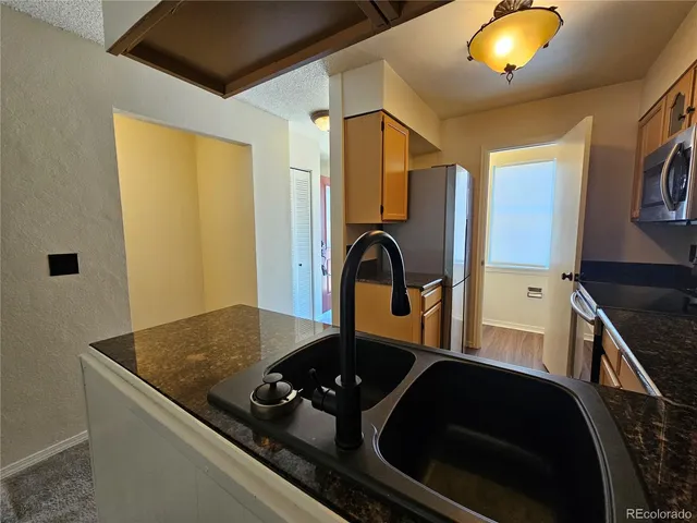 a kitchen with a sink and a stove top oven