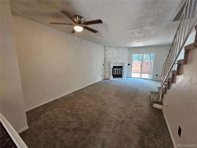 wooden floor in an empty room with a fireplace
