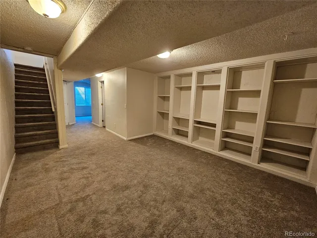 a view of an empty room with a fireplace