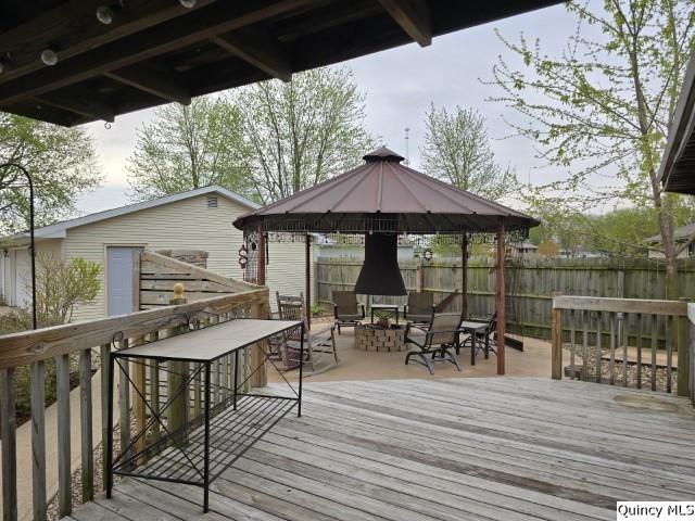 704 Orchard Lane Carthage, IL 62321 - Photo 33 of 36 a view of a patio with table and chairs under an umbrella with wooden floor