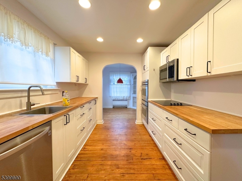 755 Preakness Avenue Wayne, NJ 07470 - Photo 12 of 35 a large kitchen with stainless steel appliances granite countertop a sink and cabinets