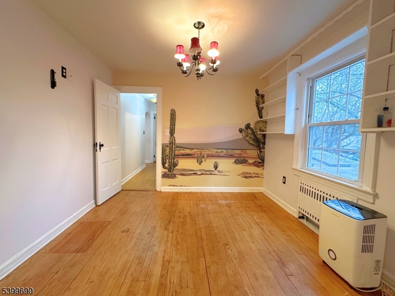 755 Preakness Avenue Wayne, NJ 07470 - Photo 15 of 35 a view of a room with wooden floor and a chandelier