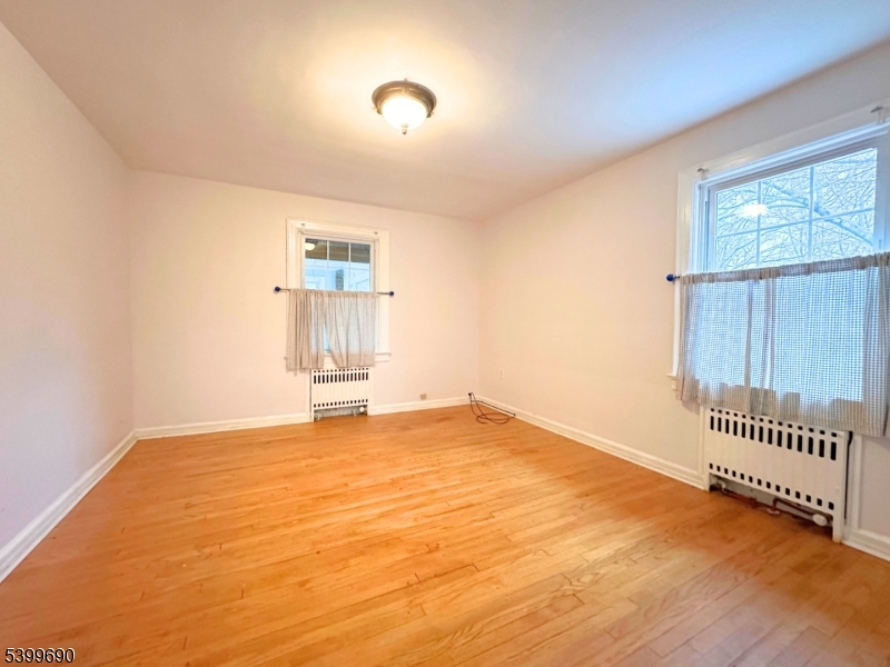 755 Preakness Avenue Wayne, NJ 07470 - Photo 17 of 35 an empty room with wooden floor and windows