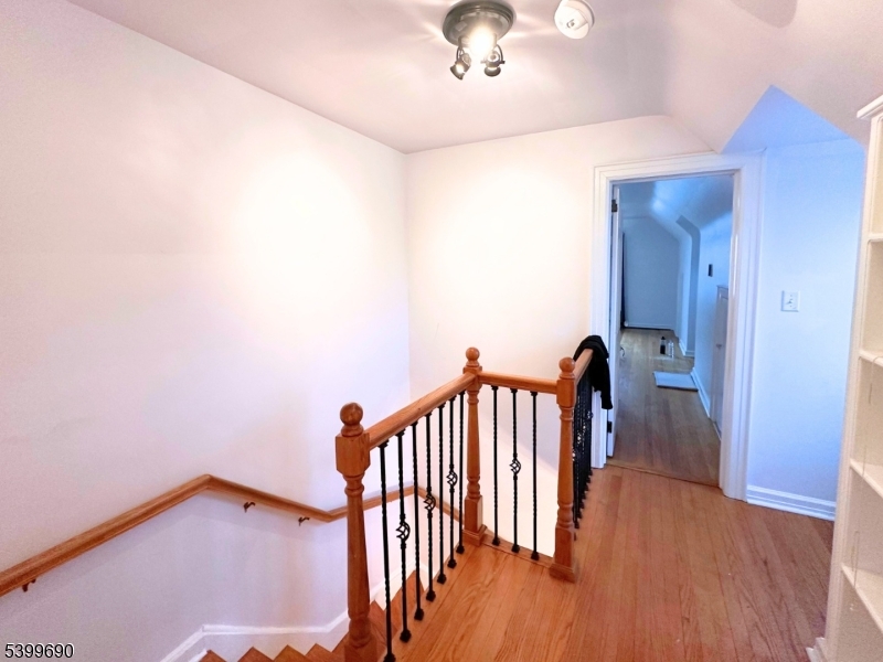 755 Preakness Avenue Wayne, NJ 07470 - Photo 19 of 35 a view of a hallway with wooden floor and staircase