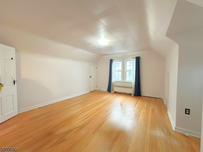 755 Preakness Avenue Wayne, NJ 07470 - Photo 20 of 35 a view of an empty room with wooden floor and window