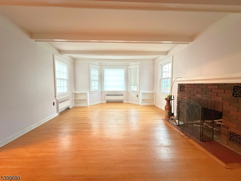 755 Preakness Avenue Wayne, NJ 07470 - Photo 7 of 35 a view of empty room with fireplace and windows