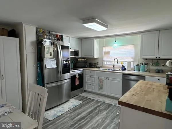 a kitchen with a refrigerator stove and sink