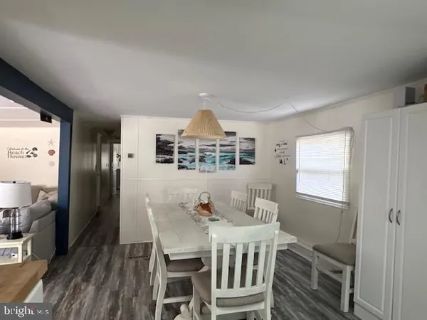 a dining room with furniture a chandelier and wooden floor