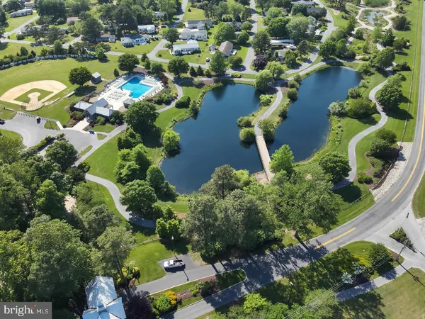 an aerial view of residential houses with outdoor space and swimming pool