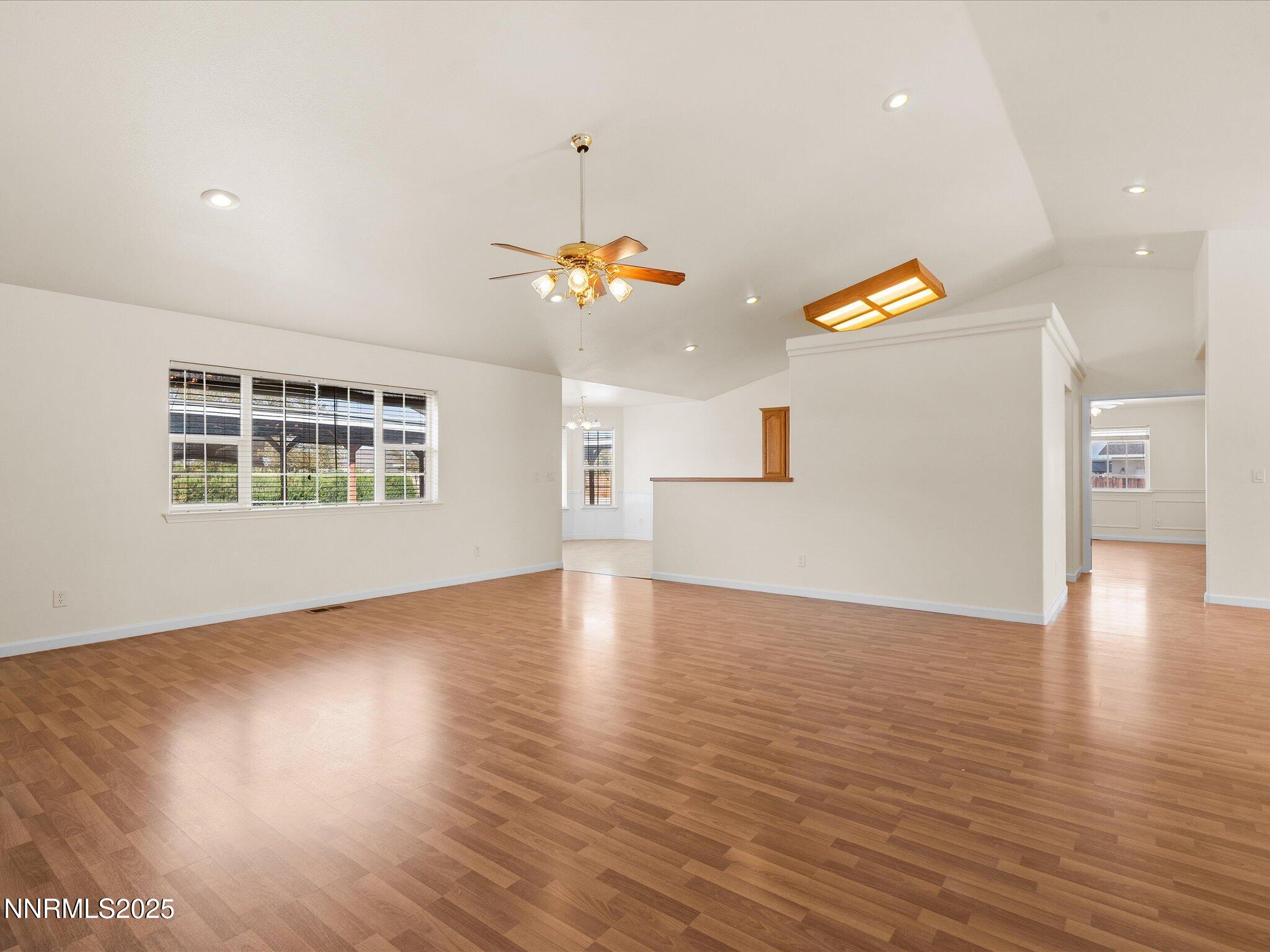 696 Sunrise Terrace Fallon, NV 89406 - Photo 17 of 65 an empty room with wooden floor and windows