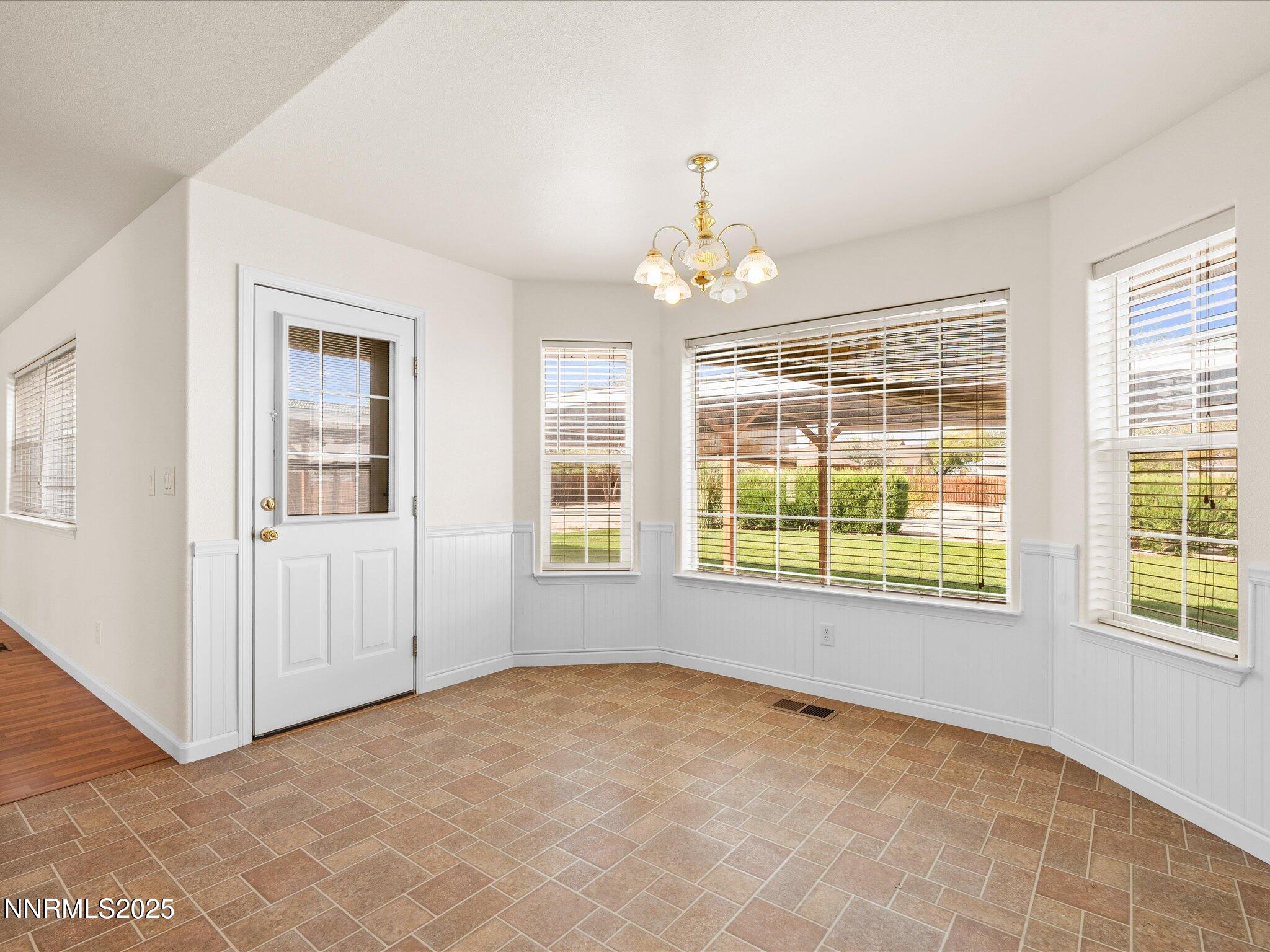 696 Sunrise Terrace Fallon, NV 89406 - Photo 25 of 65 an empty room with chandelier windows and chandelier