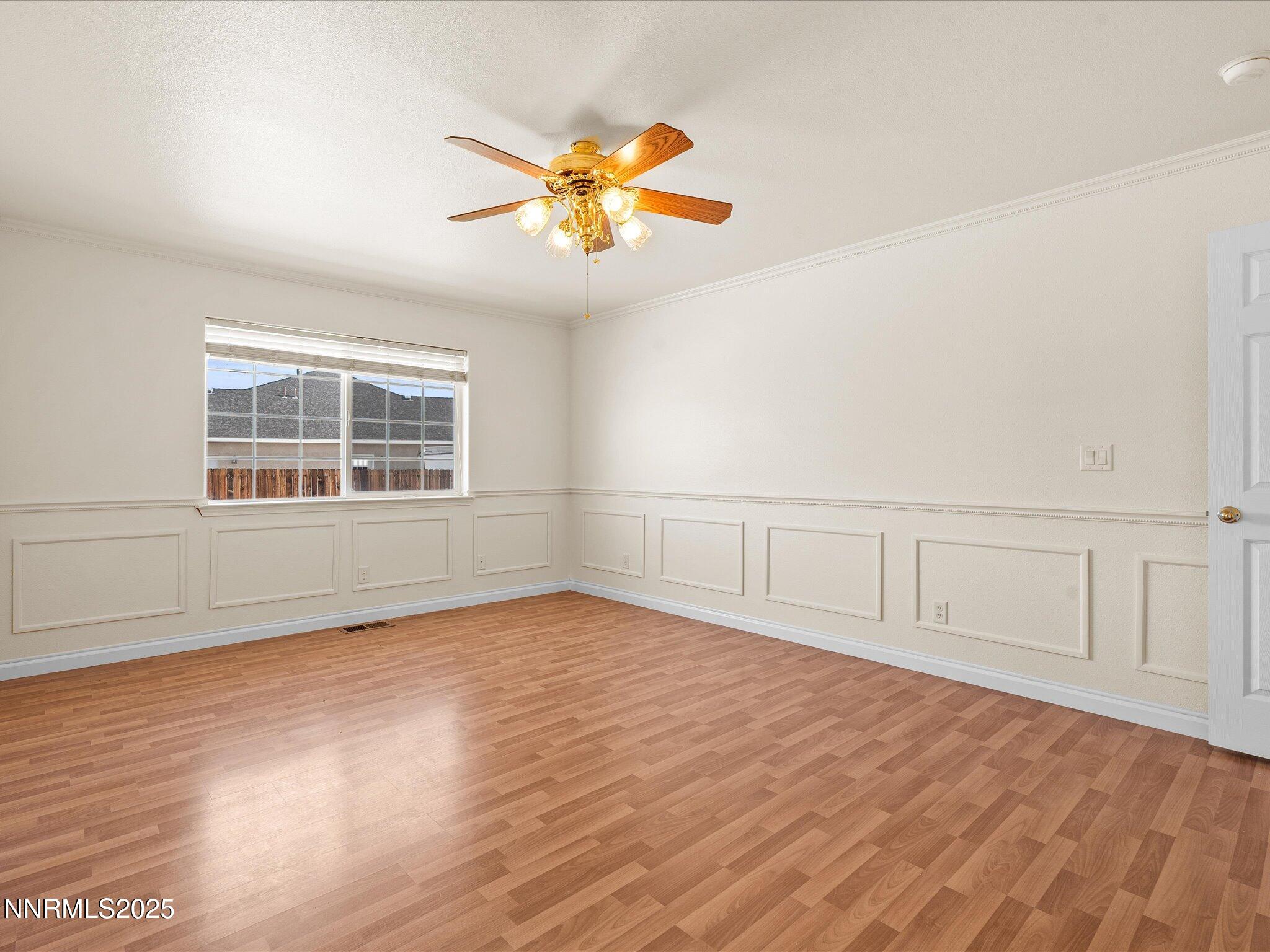 696 Sunrise Terrace Fallon, NV 89406 - Photo 28 of 65 an empty room with wooden floor and windows