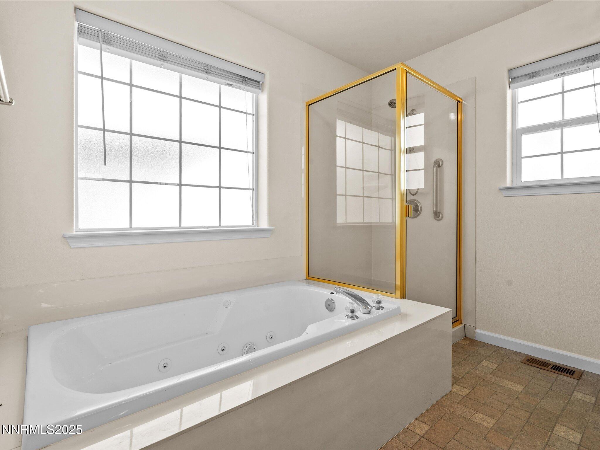 696 Sunrise Terrace Fallon, NV 89406 - Photo 32 of 65 a bathroom with a bathtub and shower