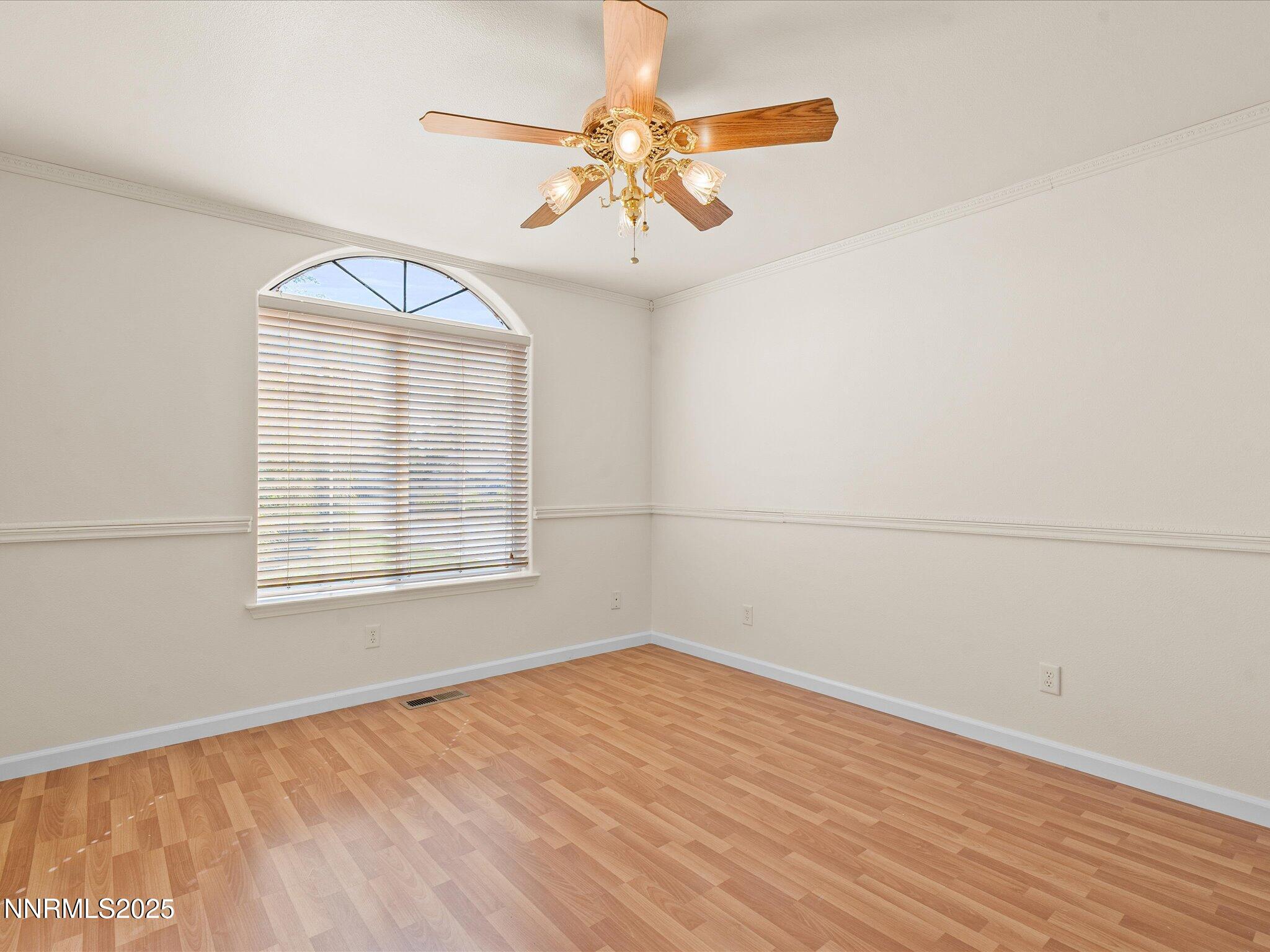 696 Sunrise Terrace Fallon, NV 89406 - Photo 37 of 65 an empty room with wooden floor fan and windows