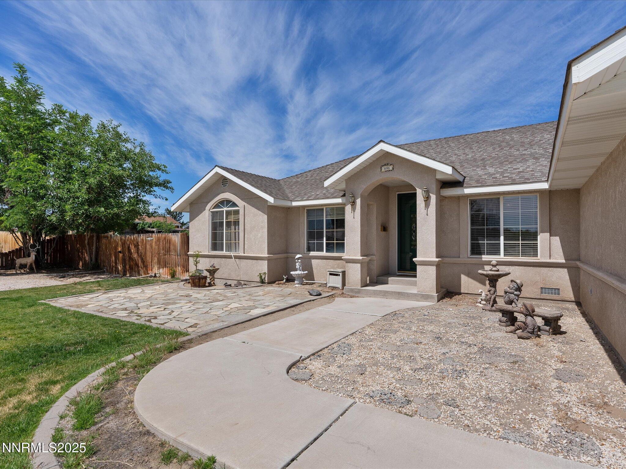 696 Sunrise Terrace Fallon, NV 89406 - Photo 8 of 65 a front view of a house with sitting area and garden