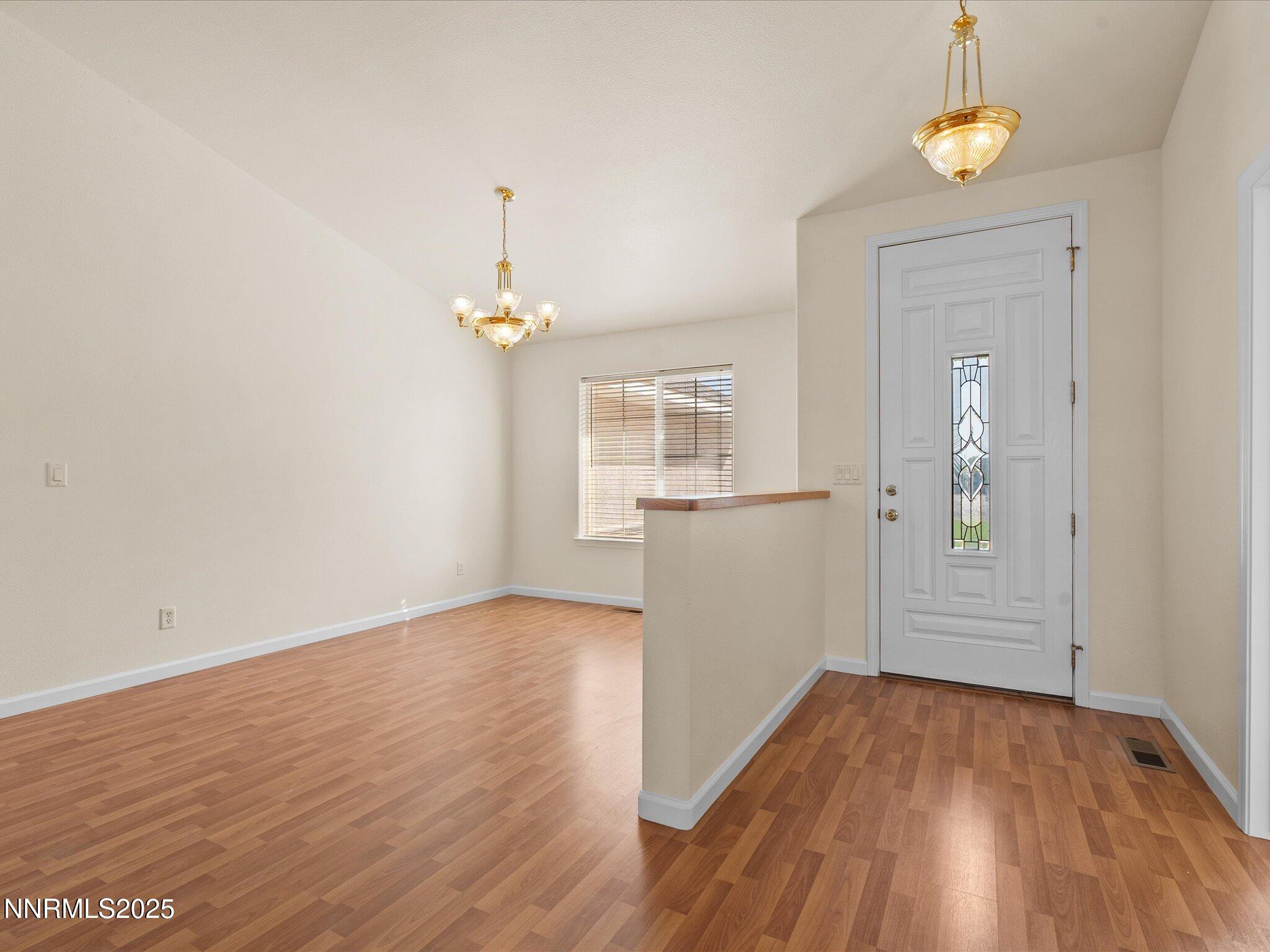 696 Sunrise Terrace Fallon, NV 89406 - Photo 10 of 65 wooden floor in an empty room with a window