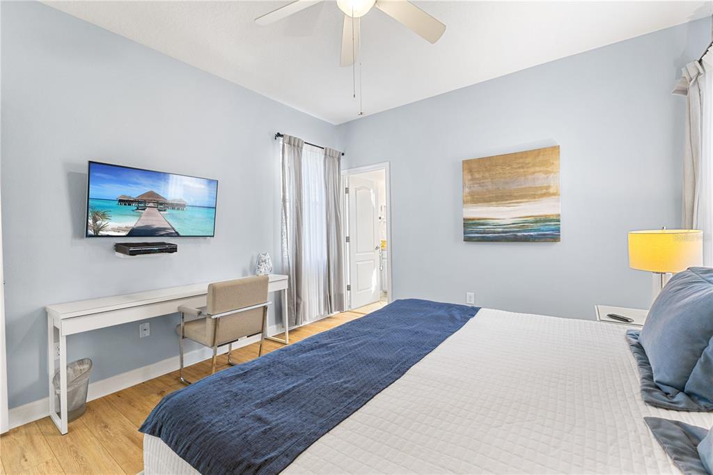 9006 Majesty Palm Road Kissimmee, FL 34747 - Photo 25 of 56 a bedroom with a bed and a flat screen tv
