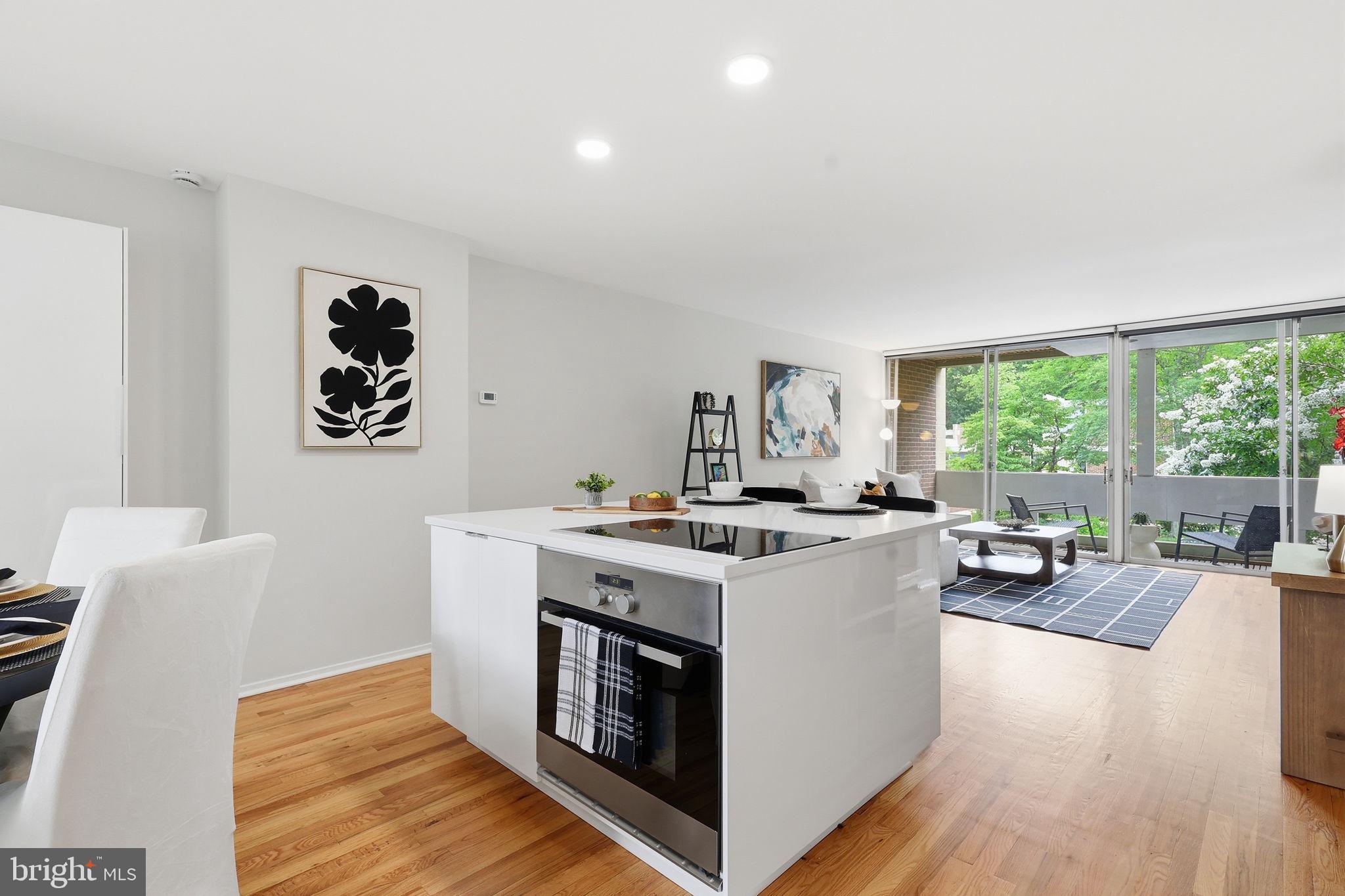 11510 Maple Ridge Road Reston, VA 20190 - Photo 15 of 43 a view of a kitchen counter top space with stove and wooden floor