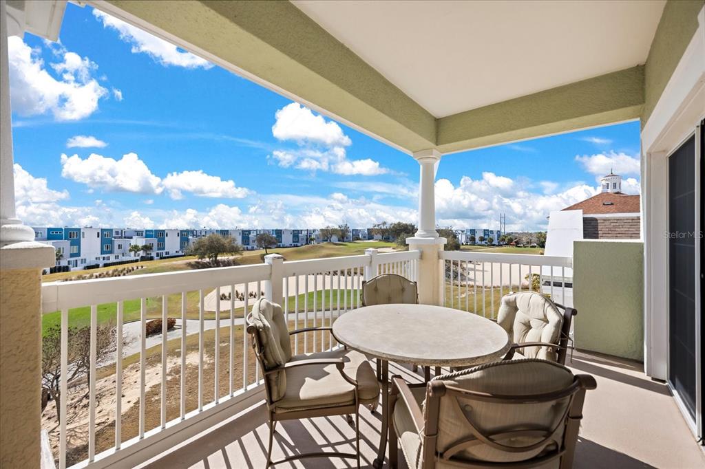 1114 Sunset View Circle, Unit 402 Reunion, FL 34747 - Photo 13 of 32 a view of a balcony with table and chairs