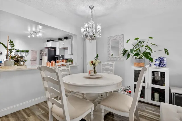 a dining room with furniture and chandelier